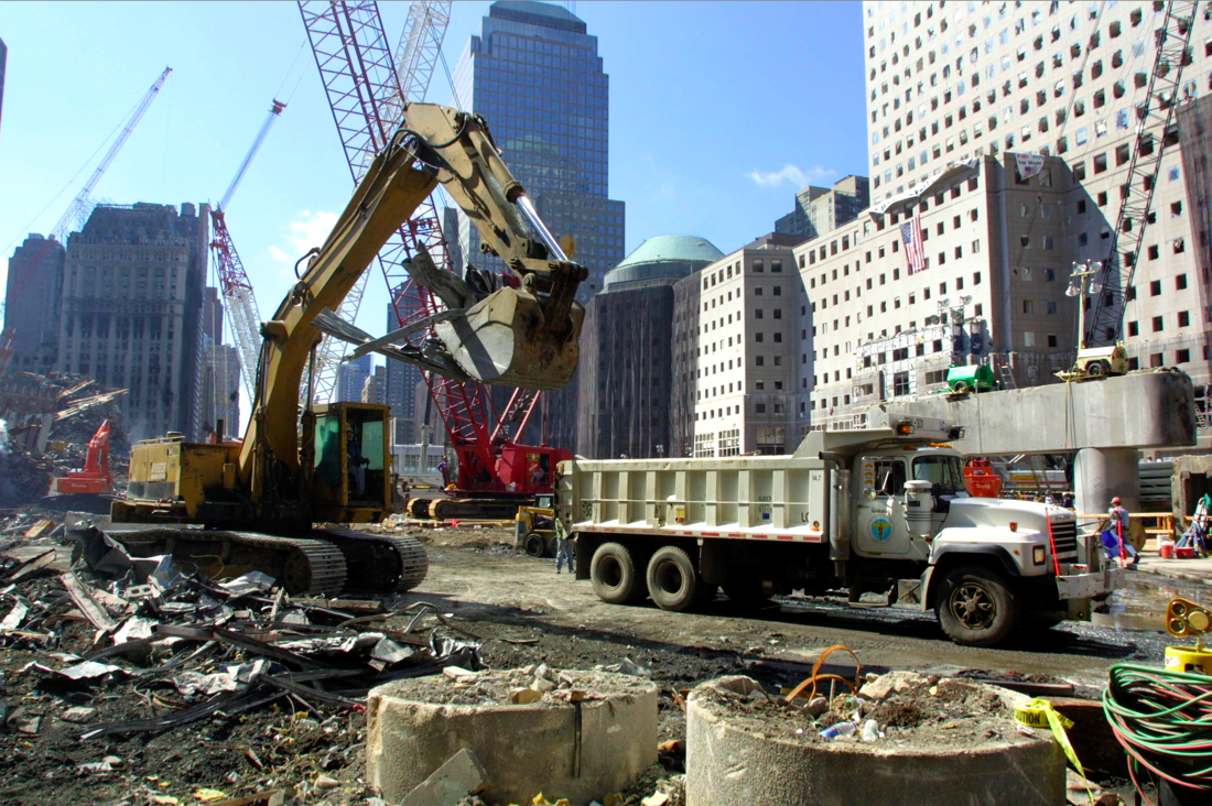 Excavator loading debris and material into a DSNY Cutdown.